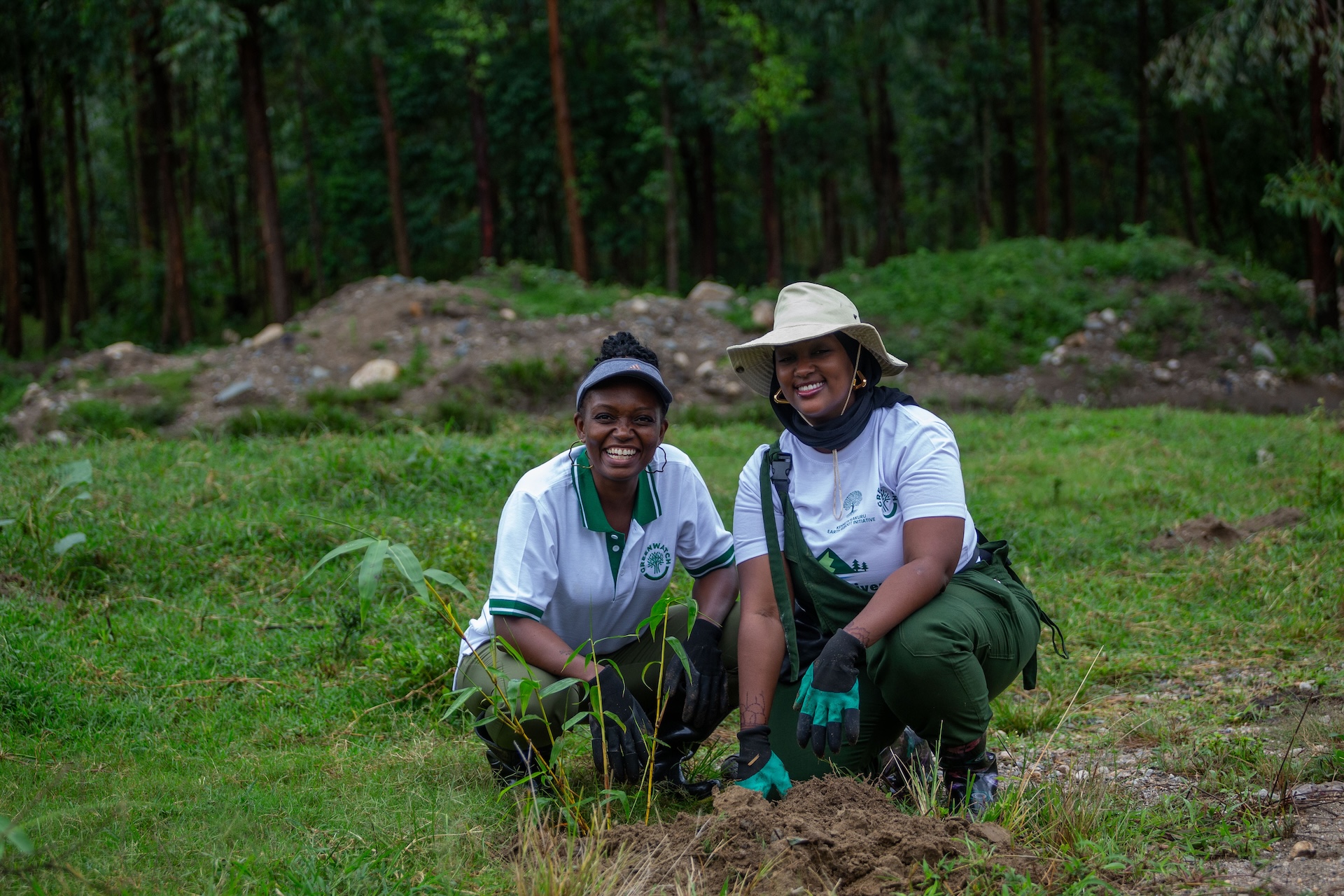 Greenwatch Director Atukunda Samantha and Kenneth Kakuru Earth Reboot Initiative Director Rose Kakuru Ikiriza share a moment after planting bamboo along River Rwembya