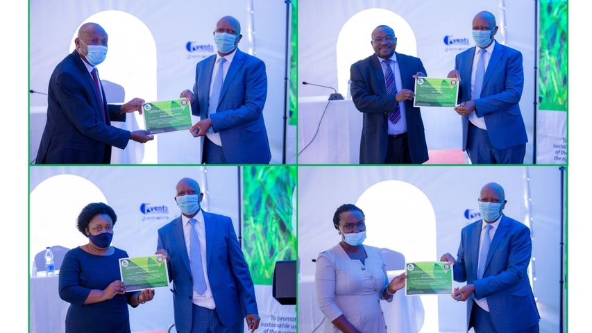 Justice Kenneth Kakuru presents certificates of participation to some of the judicial officers at the end of the third judicial training on climate justice