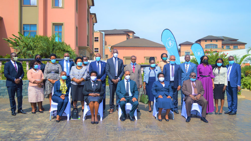 Participants pose for a group photo with the Hon. Justice Richard Buteera - Deputy Chief justice of Uganda (center-seated) after the official opening of the third judicial training on climate justice at Mestil Hotel &amp; Residences, Kampala.